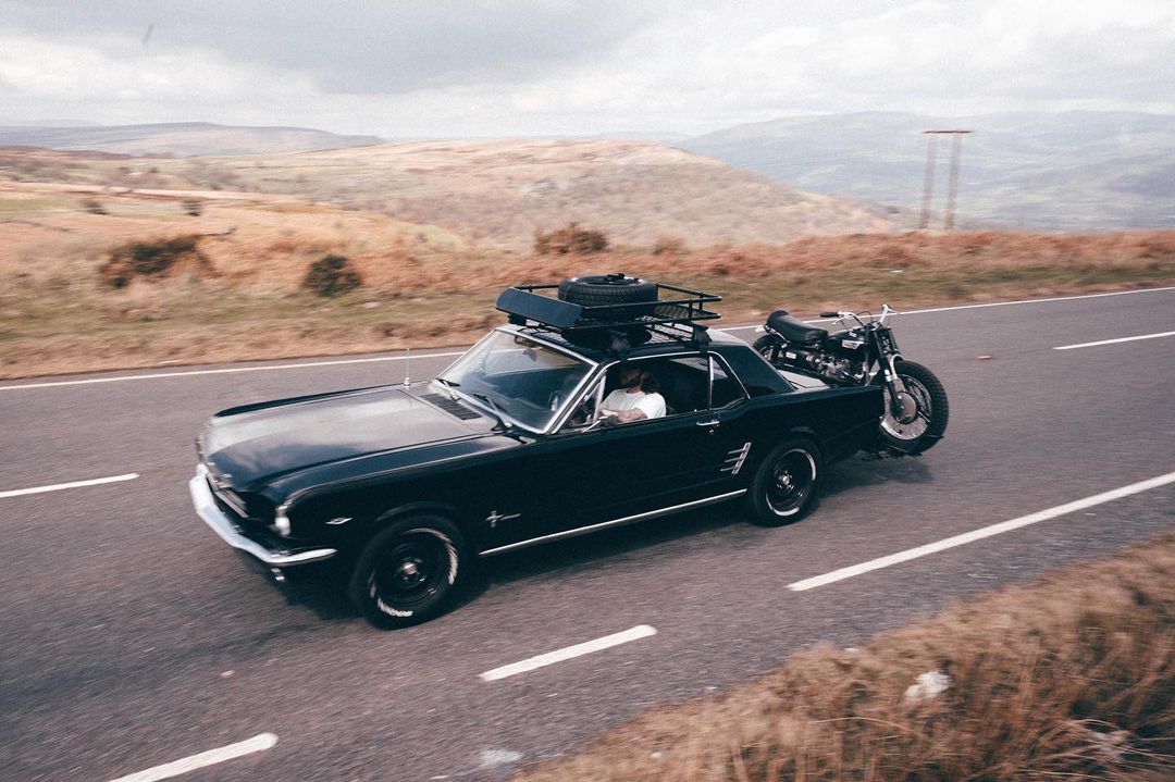 Ford Mustang Hauling a Scrambler Motorcycle on a Motorcycle Hitch Carrier
