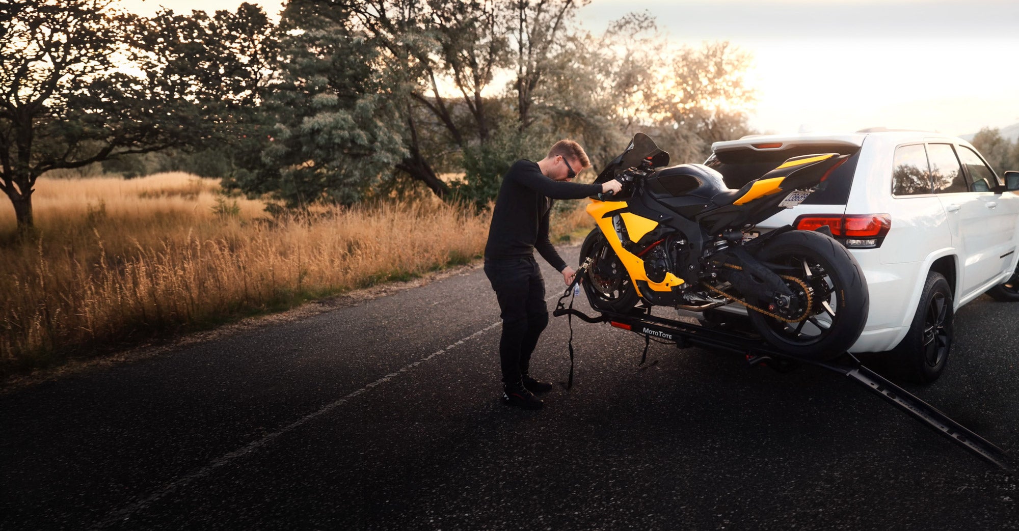 Yamaha R1 sport motorcycle being secured on a MotoTote Max+ motorcycle carrier using a sport bike tie-down system, showcasing stable and secure motorcycle transport for high-performance motorcycles.