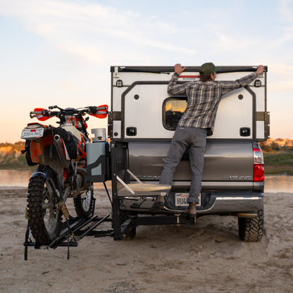Dirt bike mounted on a MotoTote mM3 motorcycle hitch carrier attached to a Toyota Tundra with a RIGd RambleSwing Pro swing-out hitch system.