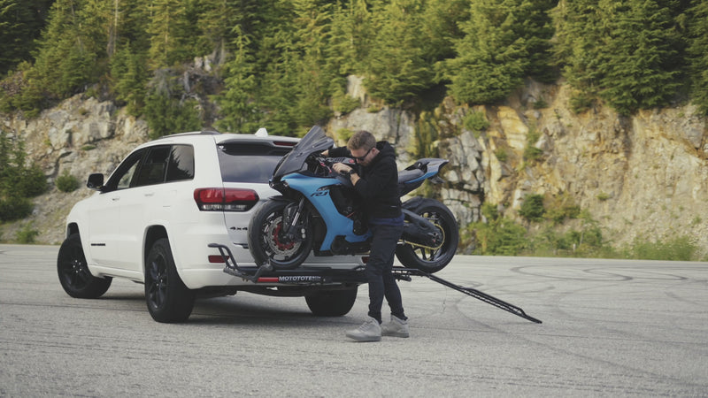 Yamaha R9 sport motorcycle being unloaded from a MotoTote Sport motorcycle hitch carrier before riding away on a scenic road adventure.